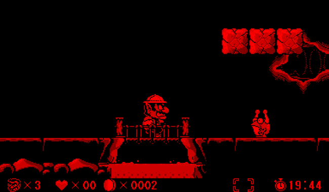 Animated graphic of the "Wario Land" game being played on a Nintendo Virtual Boy.