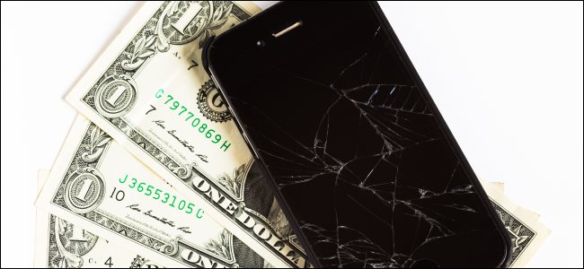A broken iPhone and some dollar bills.