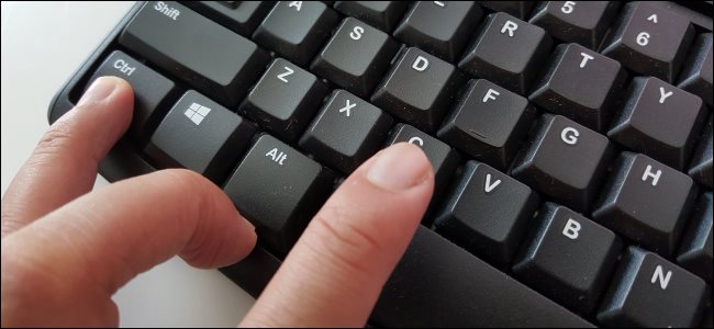 Fingers pressing Ctrl+C to copy text on a PC keyboard.