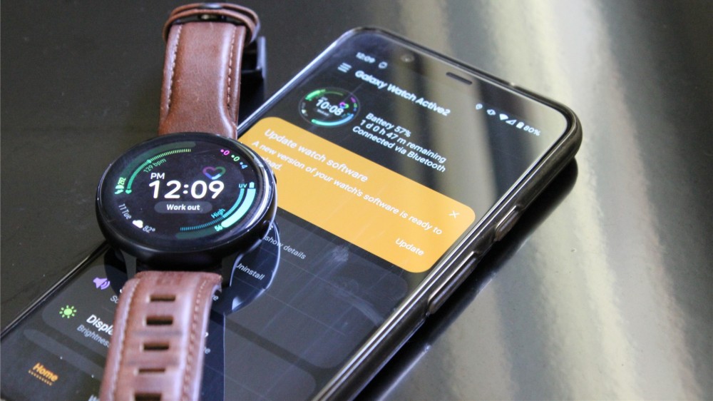 The Samsung Galaxy Watch Active 2 laying on top of the Pixel 4 XL