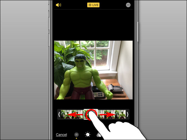 Use your finger to select a key photo on the filmstrip in Photos on iPhone.